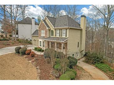 Charming two-story home featuring a stone facade, covered front porch, and well-manicured landscaping at 582 Braidwood Nw Dr, Acworth, GA 30101