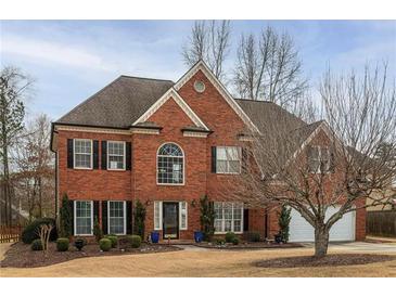 Beautiful two-story brick home with a well-manicured front lawn and a two-car garage at 1219 Hadaway Ct, Lawrenceville, GA 30043