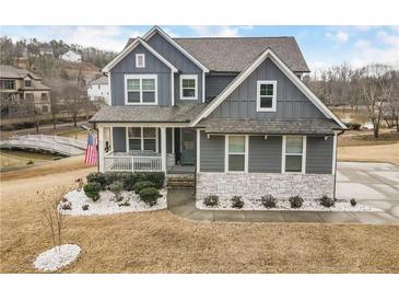 Charming gray two-story home featuring a welcoming front porch and beautiful landscaping at 15 Lakeside Way, Cartersville, GA 30121