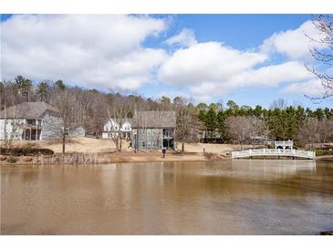 Scenic water view showing a foot bridge over the pond and well-maintained landscaping at 15 Lakeside Way, Cartersville, GA 30121