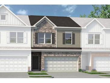 Charming townhome featuring a stone and siding exterior, two-car garage, and well-manicured landscaping at 16 Jacobs Farm Ln # 8, Lawrenceville, GA 30045