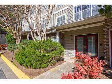 Charming townhouse exterior with well-maintained landscaping and a welcoming entrance at 2700 Pine Tree Ne Rd # 4006, Atlanta, GA 30324