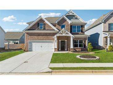 Beautiful two-story brick home with a well-manicured lawn and inviting entrance at 744 Clark Lake Estates Dr, Grayson, GA 30017