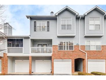 Inviting townhome with charming architectural details, a covered balcony and convenient garage parking at 805 Vinings Forest Se Ln, Smyrna, GA 30080