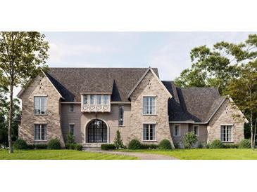 Stunning new traditional home with a brick facade, arched entry, and professionally landscaped lawn at 133 Laurel Brook Ln, Canton, GA 30115