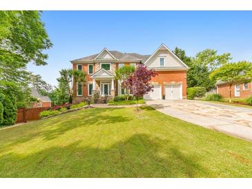 Beautiful two-story brick home with a well-manicured lawn and attached two-car garage at 1250 Rosette Way, Marietta, GA 30062