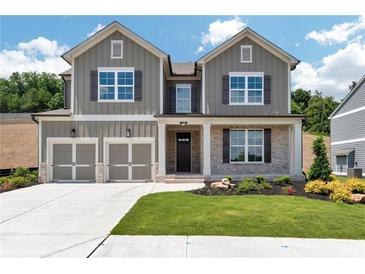 Charming two-story home featuring a two-car garage and beautifully landscaped front yard at 329 Willow Cv, Canton, GA 30114