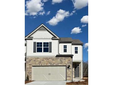 Charming two-story home with stone accents, gray shutters, a two-car garage, and a welcoming front door at 2474 Bayberry St # 33, Acworth, GA 30101