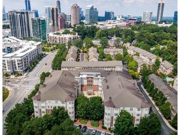 A stunning aerial view of a townhome community with the city skyline in the background at 3635 E Paces Ne Cir # 1405, Atlanta, GA 30326