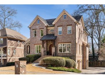 Stately two-story brick home with manicured landscaping and charming architectural details at 1207 Thornwell Ne Dr, Brookhaven, GA 30319