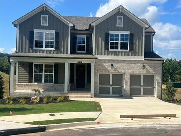 Charming two-story home featuring a brick facade and a two-car garage at 219 Willow St, Canton, GA 30114