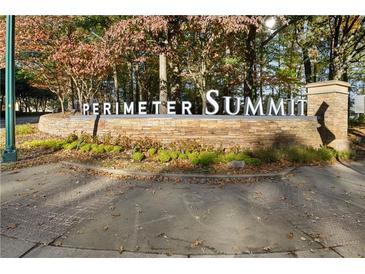 Stone Perimeter Summit community sign surrounded by mature trees and greenery in a landscaped setting at 10 Perimeter Summit Ne Blvd # 4243, Brookhaven, GA 30319