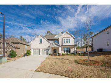 View of the front exterior of the two-story home with three-car garage and large front yard at 614 Denali Dr, Mableton, GA 30126