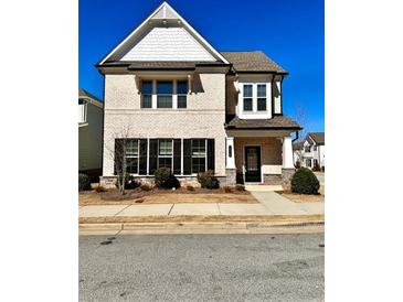 Charming brick two-story home with manicured landscaping and inviting front porch at 4316 Waxwing St, Hoschton, GA 30548