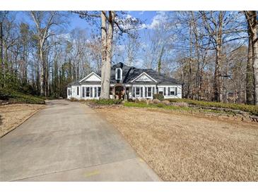 Charming single-story home featuring a black roof, white siding, and a well-manicured front yard at 6170 Wellington Ct, Cumming, GA 30040