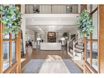 Grand living room with coffered ceilings, fireplace, and open floor plan, perfect for entertaining guests in style at 6170 Wellington Ct, Cumming, GA 30040