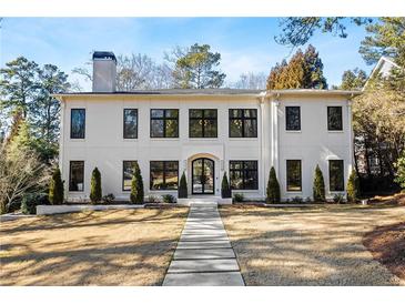 Stunning two-story home featuring modern architecture, black-framed windows, and a beautifully landscaped front yard at 4132 Carmain Ne Dr, Atlanta, GA 30342