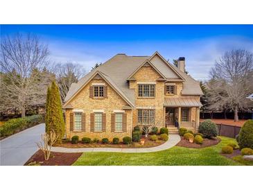 Charming two-story brick home with manicured lawn and mature landscaping at 2953 Kings Walk Ave, Marietta, GA 30062