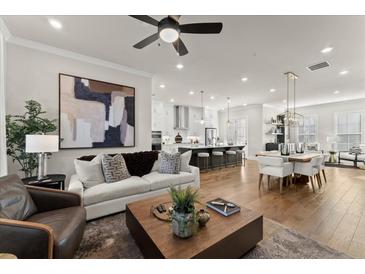 Bright living room featuring modern decor, a ceiling fan, and an open floor plan at 425 Burton Dr, Alpharetta, GA 30009