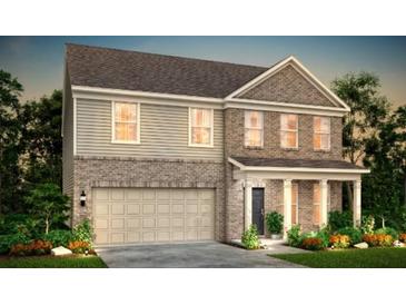 Charming two-story home features a two-car garage, covered entry, and landscaped front yard at 6095 Marigold Way, Atlanta, GA 30349