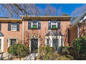 Charming brick townhome featuring black shutters and manicured landscaping at 1281 Whitlock Ridge Sw Dr, Marietta, GA 30064