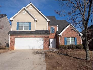 Charming two-story home featuring a brick facade, attached two-car garage, manicured front yard, and blue window shutters at 452 Parkside Way, Mcdonough, GA 30253