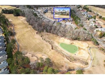 Breathtaking aerial view of property overlooking a lush golf course and surrounded by mature trees at 250 High Court Way, Locust Grove, GA 30248