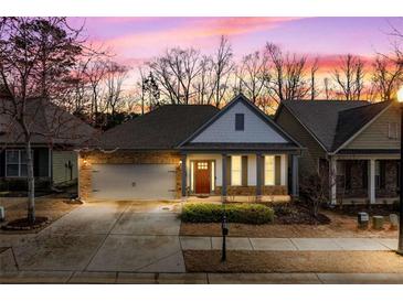 Charming single-story home with a brick and siding exterior, attached garage, and manicured landscaping at 250 High Court Way, Locust Grove, GA 30248