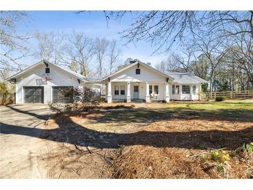 Charming home with inviting front porch, attached garage and basketball hoop at 915 Homer Rd, Woodstock, GA 30188