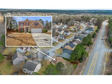 A lovely neighborhood is revealed in this aerial view, complete with well-maintained homes and tree-lined streets at 6498 Stonelake Sw Pl, Atlanta, GA 30331