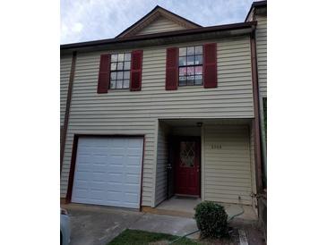 Two-story home featuring red shutters and a single-car garage at 2303 Pine Tree Trl, Atlanta, GA 30349