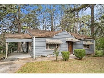 Exterior front view of a single story home with a covered porch and a small landscaped yard at 2057 Akron Se Dr, Atlanta, GA 30315