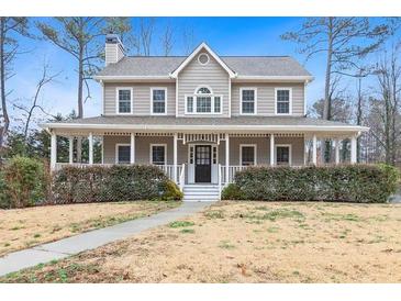 Charming home featuring a welcoming front porch and manicured landscaping at 194 Preston Nw Pl, Dallas, GA 30157