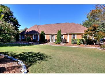 Charming single-story home with a well-manicured lawn and inviting entrance at 3889 Pineybrook Dr, Loganville, GA 30052