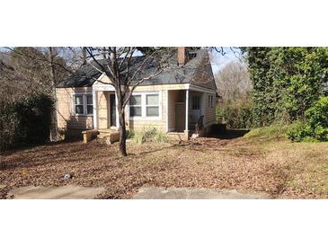 A quaint single-Gathering home with a traditional design, surrounded by trees at 1497 Clermont Ct, Atlanta, GA 30344
