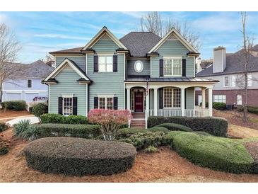 Charming two-story home with a covered porch and beautifully landscaped front yard at 2460 Millwater Crossing Xing, Dacula, GA 30019