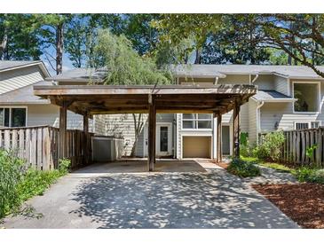 Exterior view of a townhome with a carport and a privacy fence at 2106 Clairmeade Valley Ne Rd, Atlanta, GA 30329