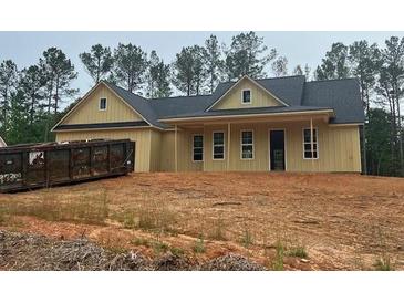 Charming, new construction, one-story home with vertical siding and dark roof in wooded setting at 554 Presley Farm Pkwy, Rockmart, GA 30153