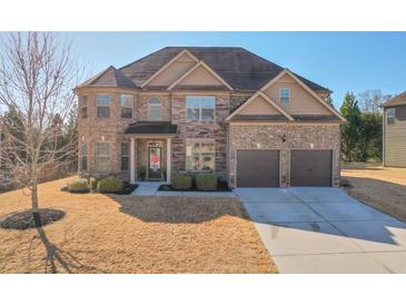 Beautiful two-story brick home with a well-manicured lawn and a two-car garage at 5315 Hidden Valley Ln, Cumming, GA 30028