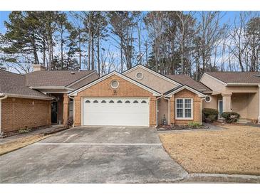 Charming brick home with a well-maintained front yard and a two-car garage at 4203 Jordans Bank, Union City, GA 30291