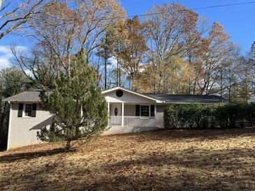 Charming single-story home with a well-maintained yard and a welcoming front porch at 3387 Forest Hill Rd, Powder Springs, GA 30127