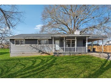 Charming single-story home features a carport, covered porch, and well-maintained lawn at 401 Cabriolet Ct, Mcdonough, GA 30253