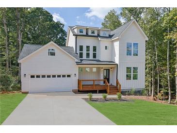 Charming new two-story home with white siding, inviting porch, attached garage, and manicured front yard at 553 Somersby Dr, Dallas, GA 30157