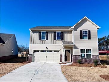 Charming two-story home with a brick-accented foundation and a well-manicured front yard at 7714 Sudbury Cir, Covington, GA 30014