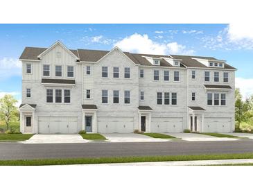 New townhome community featuring multi-story buildings with attached garages, stone facades and stylish architectural details at 6228 Kenbrook Dr, Tucker, GA 30084