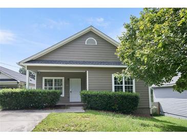 Charming single-story home with neutral siding, manicured hedges, and well-maintained front lawn at 848 Capitol View Nw Ave, Atlanta, GA 30318