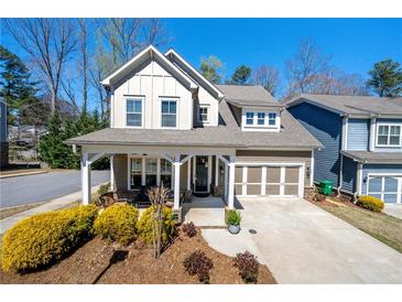 Charming two-story home with a welcoming front porch and a well-manicured landscaped yard at 2434 Soft Maple St, Atlanta, GA 30360