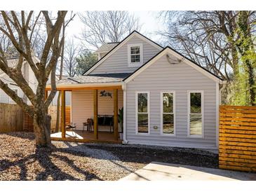 Charming bungalow with a welcoming front porch and modern gray siding, complemented by a neatly landscaped yard at 731 Hobart Se Ave, Atlanta, GA 30312