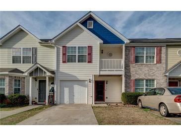 Charming townhome featuring a garage, quaint balcony, and lovely curb appeal at 1769 Old Dogwood, Jonesboro, GA 30238