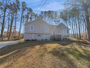 Charming two-story home with gray siding, a bay window and mature trees at 2473 Chauncey Sw Ln, Marietta, GA 30064